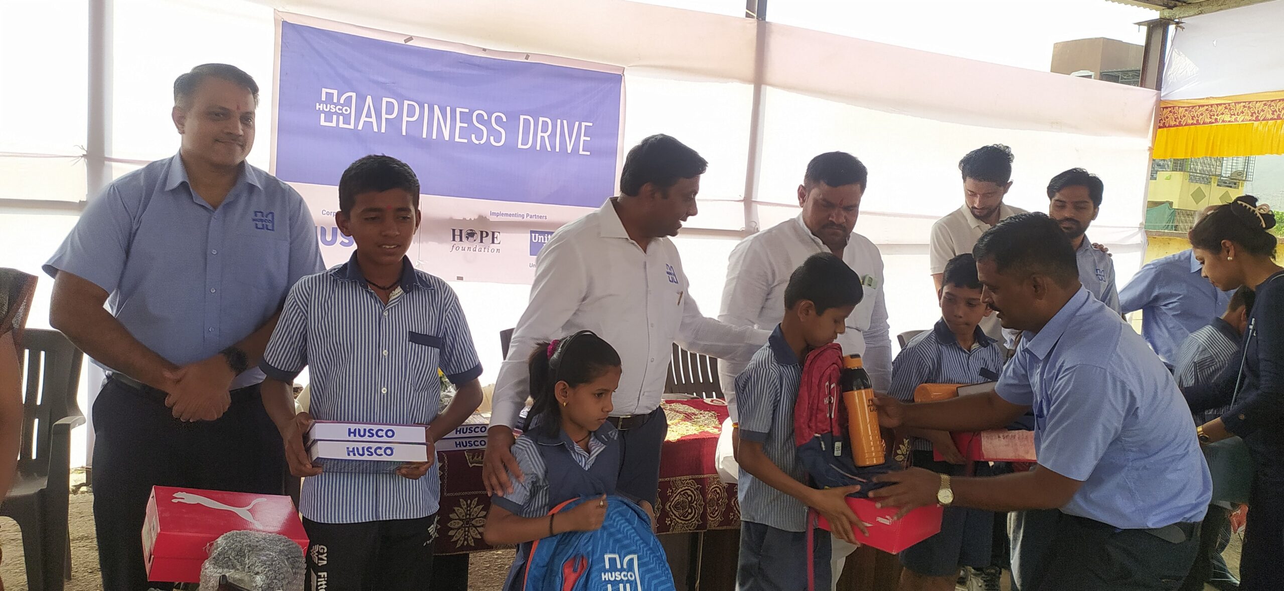 Students from ZP school, Pune, receiving educational resources under UW India’s Happiness Drive.